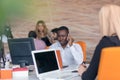 Happy smiling successful African American businessman in in a modern bright startup office indoors Royalty Free Stock Photo