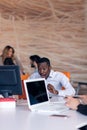 Happy smiling successful African American businessman in in a modern bright startup office indoors Royalty Free Stock Photo