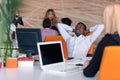 Happy smiling successful African American businessman in in a modern bright startup office indoors Royalty Free Stock Photo