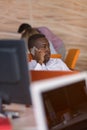 Happy smiling successful African American businessman in in a modern bright startup office indoors Royalty Free Stock Photo