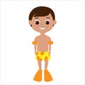 Happy smiling tanned boy in bright yellow shorts, flippers and rubber sleeves.