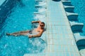 Happy smiling tanned man relaxing in pool jacuzzi outdoor at spa resort enjoying luxury life. Success, healthy lifestyle, body car Royalty Free Stock Photo