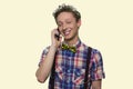 Happy smiling teen boy talking on cell phone. Royalty Free Stock Photo