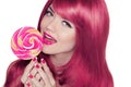 Happy smiling teen girl holding multicolored lollipop with pink Royalty Free Stock Photo