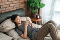 Smiling teenage asian girl using smartphone Royalty Free Stock Photo