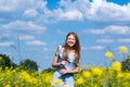 Happy smiling teenage girl having fun in nature. Ukrainian girl on yellow and blue background. Colors of Ukrainian flag.