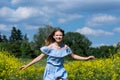 Happy smiling teenage girl having fun in nature. Ukrainian girl on yellow and blue background. Colors of Ukrainian flag.