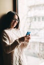 Happy smiling teenage girl texting on cell phone Royalty Free Stock Photo