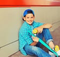 Happy smiling teenager boy with skateboard in casual on city street Royalty Free Stock Photo