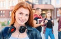 Happy smiling teenager girl with freckles with group of students on background Royalty Free Stock Photo