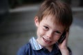 Daddy is calling, happy toddler boy with mobile phone Royalty Free Stock Photo