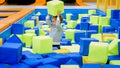 Happy smiling toddler boy playing and throwing soft cubes in big pit at playroom in mall