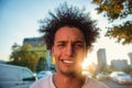 Happy smiling urban hipster young man using smart phone. African american teenager holding mobile smartphone on sunset Royalty Free Stock Photo