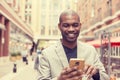 Happy smiling urban professional man using smart phone Royalty Free Stock Photo