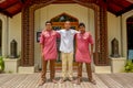 Happy smiling waiters team standing in uniform in front of arabic restaurant