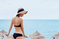 Happy smiling woman in bikini and sunhat on sea beach Royalty Free Stock Photo