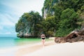 Happy smiling woman in bikini and sunhat walking on sea beach. Royalty Free Stock Photo