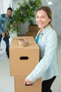 happy smiling woman carrying carton boxes moving Royalty Free Stock Photo