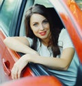 Happy smiling woman driver behind a wheel red car Royalty Free Stock Photo