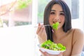 Happy smiling woman eating tomato and salad for healthy body and healthy food concept Royalty Free Stock Photo