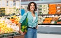 Happy smiling woman with food in reusable net bag Royalty Free Stock Photo