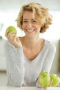 Happy smiling woman holding green apple Royalty Free Stock Photo