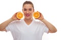 Happy smiling woman holding two pieces of oranges Royalty Free Stock Photo