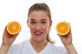 Happy smiling woman holding two pieces of oranges Royalty Free Stock Photo