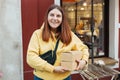 Happy smiling Woman holding two take-out food containers near restaurant. Fast food eco packaging with big breakfast set Royalty Free Stock Photo