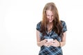 Happy smiling woman looking at cell mobile phone girl texting on smartphone isolated over white background Royalty Free Stock Photo