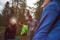 Happy smiling woman and man with headlamp flashlight during evening near camping. Group of friends people summer Royalty Free Stock Photo