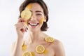 Happy smiling woman with many lemon pieces