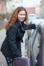 Happy smiling woman opeing car door Royalty Free Stock Photo