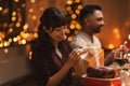 happy smiling woman opening christmas gift at home Royalty Free Stock Photo