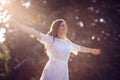 Happy smiling woman with outstretched arms stands in nature Royalty Free Stock Photo