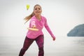 Happy smiling woman playing badminton at beach, active lifestyle Royalty Free Stock Photo