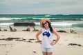 Happy smiling woman posing for a photo next to sea lions on Kangaroo Island Royalty Free Stock Photo