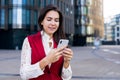 Happy smiling woman professional government worker reading good news in messenger on mobile phone