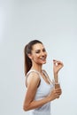 Happy Smiling Woman Taking Pill With Cod Liver Oil Omega-3 And Holding A Glass Of Fresh Water In Morning.