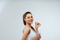 Happy Smiling Woman Taking Vitamin Pils And Holding A Glass Of Fresh Water In Morning. Vitamin D, E, A Fish Oil Capsules,Omega-3.