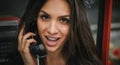 Happy and smiling woman talking in the retro phone booth Royalty Free Stock Photo