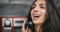 Happy and smiling woman talking in the retro phone booth Royalty Free Stock Photo