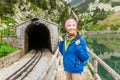 Smiling woman traveling by train on most picturesque railway road in Nuria Valley in Spain