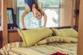 Happy smiling woman upside down in bed in the bedroom Royalty Free Stock Photo