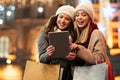 Happy women friends shopping Christmas gifts in the city. People holiday sale happiness concept Royalty Free Stock Photo