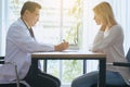 Happy and smiling woman talking to doctor psychiatrist in hospital,Discuss issue and find solutions to mental health problems