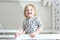 Happy smiling 2 years little girl in her bed at home