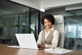 Happy young African professional business woman with laptop in office, portrait. Royalty Free Stock Photo