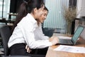Happy smiling young Asian business woman working together with colleagues in the office. Business teamwork cooperation partnership Royalty Free Stock Photo