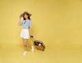 Happy smiling young Asian tourist woman holding passport ticket and luggage going to travel on summer holidays Royalty Free Stock Photo